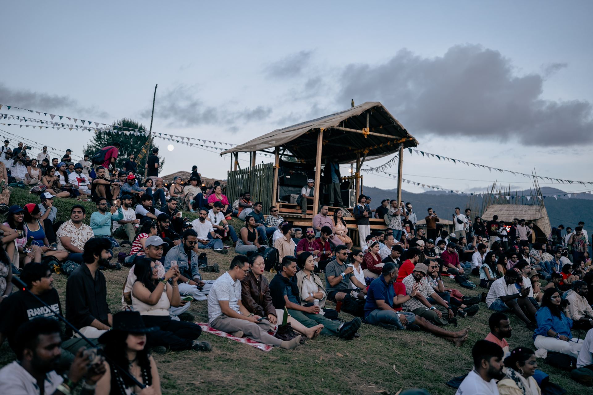 Festival crowd on the hillside at dusk in Ziro Valley